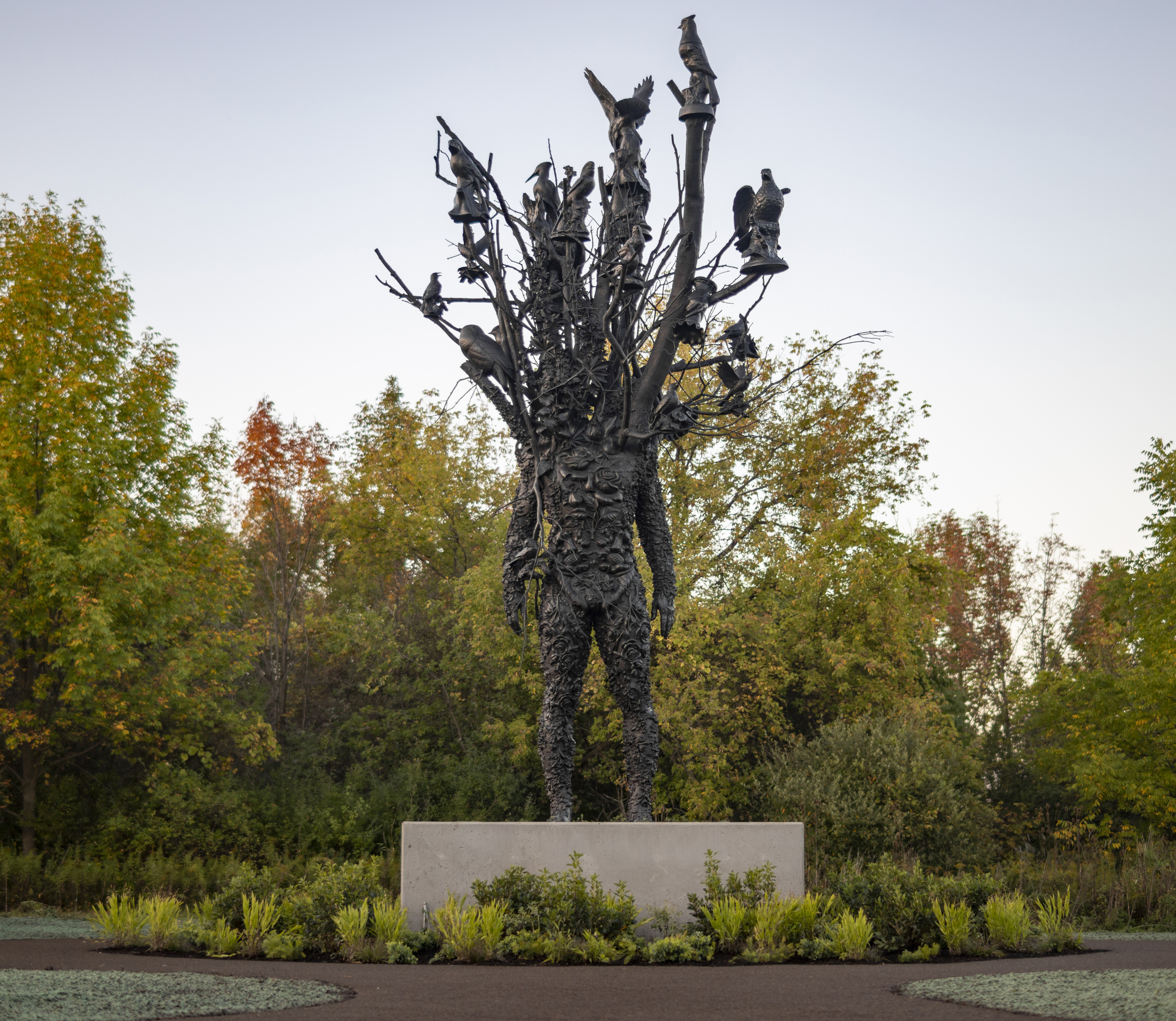 A black sculpture in front of greenery at Meijier Gardens